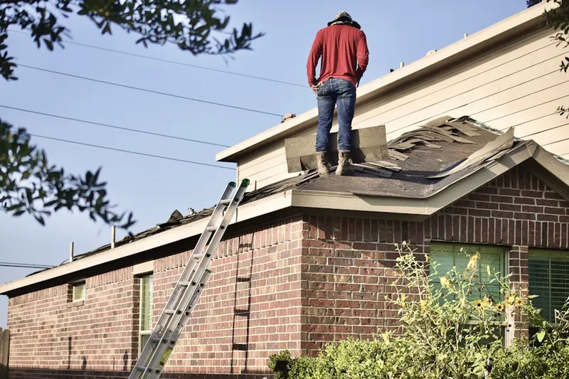 Professional roofer working on a residential roof in Swannanoa